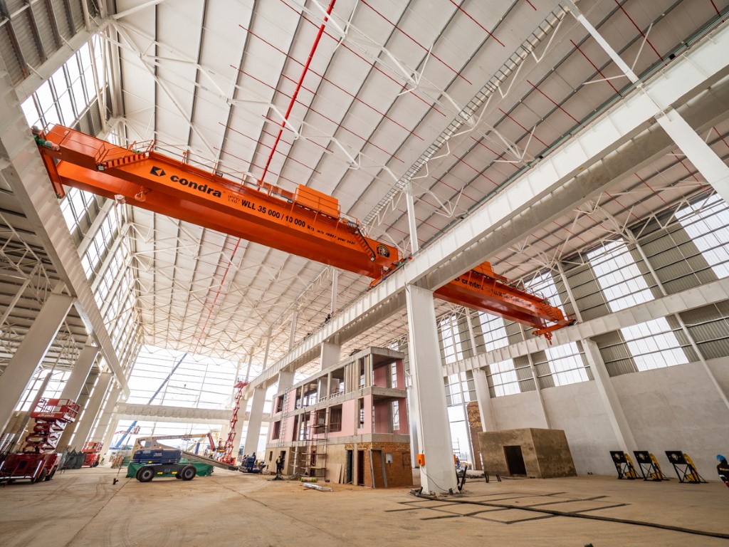 Condra overhead cranes in a factory environment.